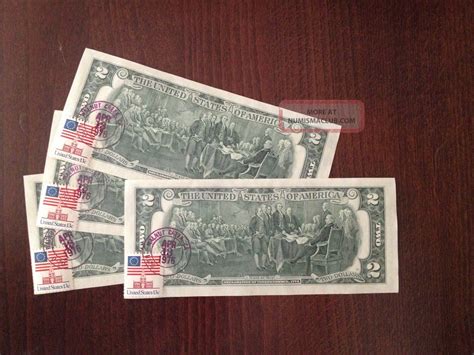 $2 bill with postage stamp