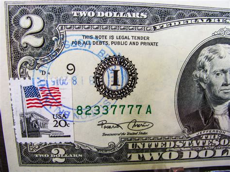 2 dollar bill with postage stamp